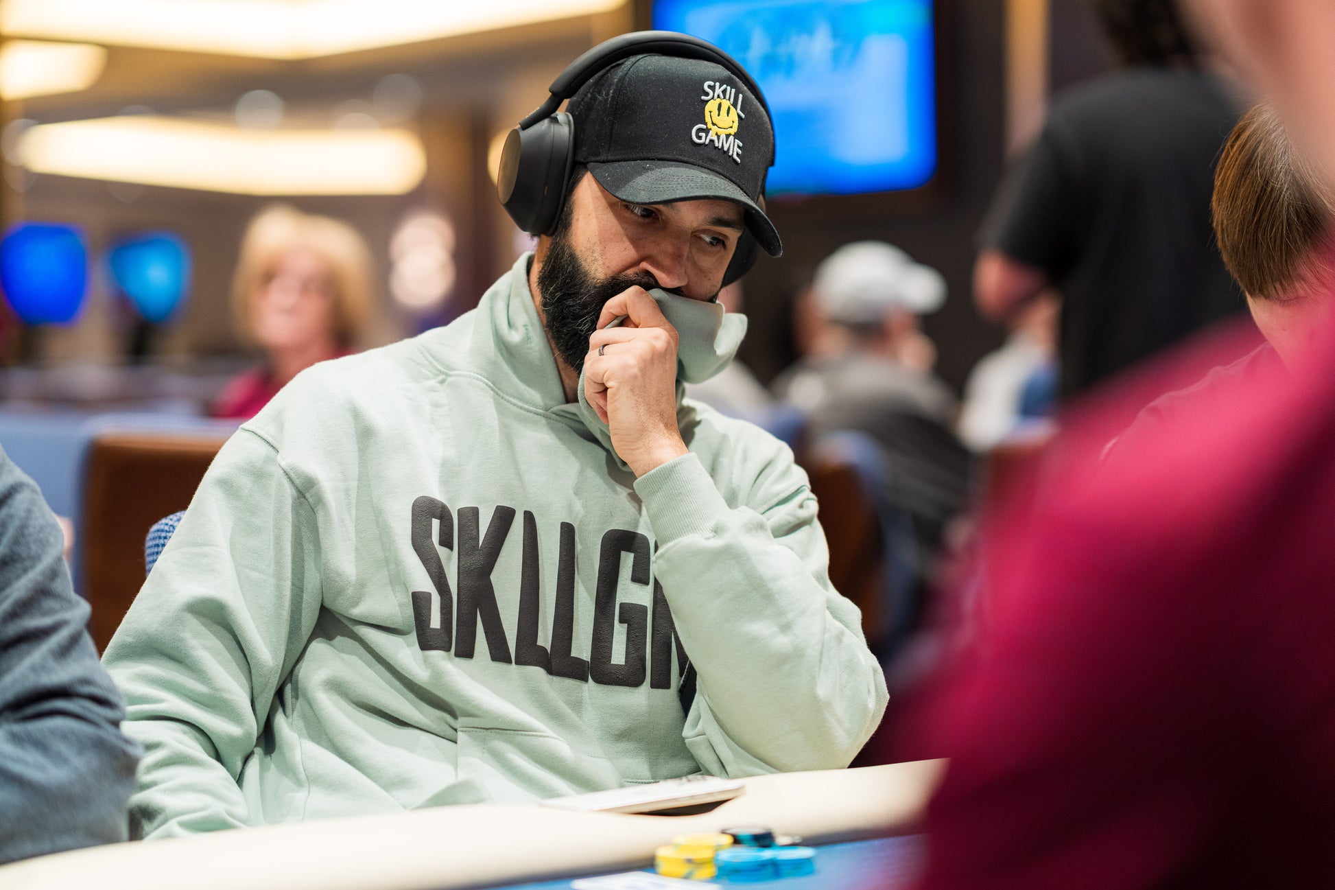 Andrew Moreno wearing the SKLLGM hoodie at the poker table